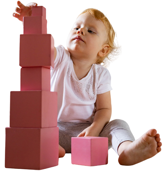 Child building Montessori pink tower at MMS