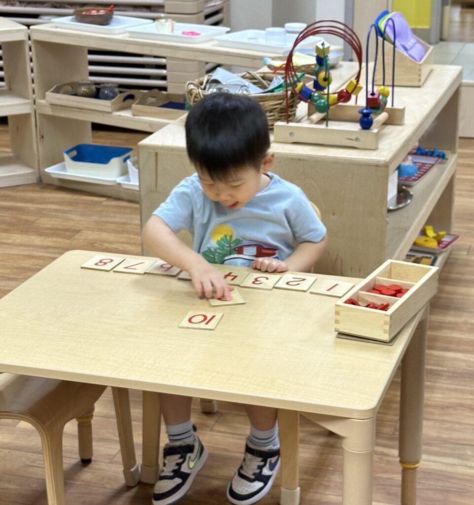 Child working with Montessori materials in our preschool for 3 year olds in Richmond TX