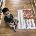 Preschool student working with Montessori materials in Early Childhood classroom at Meadow Montessori School in Richmond, TX