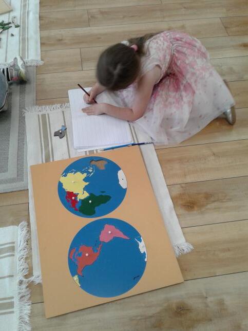 As part of the Meadow Montessori curriculum in Richmond, TX, an early childhood student works on a world map